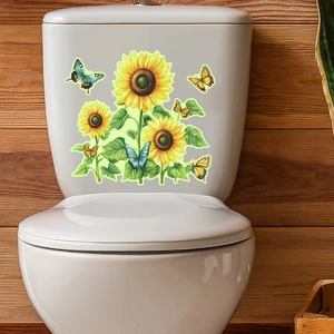 Detail of sunflower and butterfly luminous stickers applied on white toilet tank