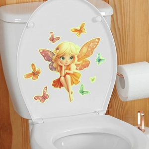Detailed view of luminous cartoon fairy and butterfly stickers applied on a white toilet lid