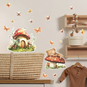 Close-up of mushroom house and sleeping bear wall stickers in a cozy nursery room