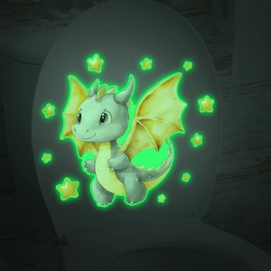 Luminous green cartoon dinosaur and stars glowing on a bathroom toilet lid in the dark