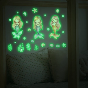 Glow-in-the-dark ocean mermaid wall stickers showing bright green fluorescence in dark bedroom