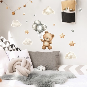 Detail showing cartoon teddy bear wall decals with clouds and stars in nursery room