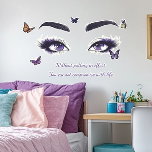 Glow-in-the-dark wall decal with butterfly and lashes over a bedroom headboard
