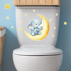 Close-up of a blue cartoon elephant sitting on a yellow moon wall sticker for kids rooms