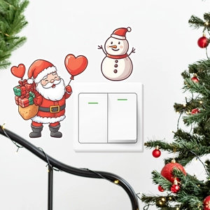 Luminous Santa and snowman decals applied to a white light switch with holiday decor