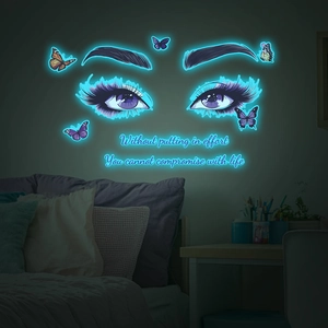 Luminous wall sticker with purple eyes and butterflies in a dark bedroom setting