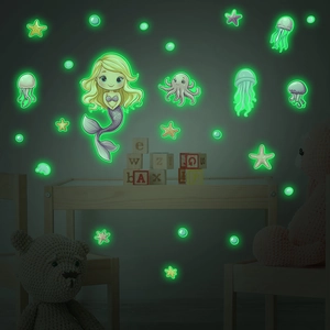 Detailed view of luminous mermaid and jellyfish wall stickers glowing in the dark