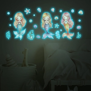 Luminous mermaid wall decals with sea stars and shells glowing in a bedroom setting