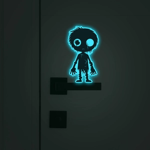 Luminous alien monster wall sticker glowing in dark near door handle decoration