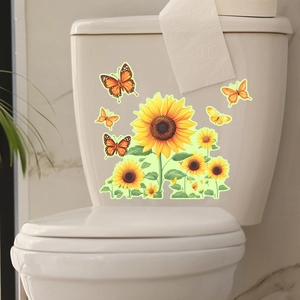 Luminous sunflower and butterfly decals applied to a white ceramic bathroom toilet tank