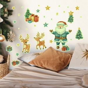 Luminous Christmas wall stickers showing Santa Claus and Reindeer glowing on a dark bedroom wall