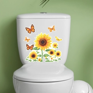 Detailed view of luminous sunflower and butterfly stickers on a white toilet tank surface