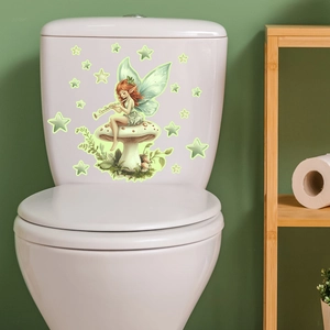 Luminous fairy and mushroom sticker applied to a white toilet tank in a bathroom setting