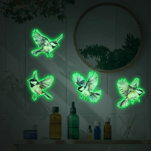 Luminous sparrow wall stickers showing glowing green flying birds in a dark bedroom setting
