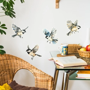 Detail view of four watercolor sparrow wall stickers displayed in a cozy home setting