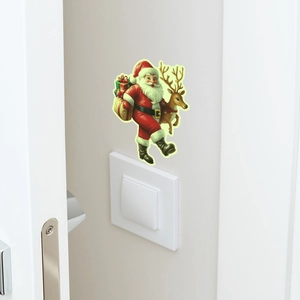 Luminous Santa Claus and reindeer wall sticker applied above a light switch plate