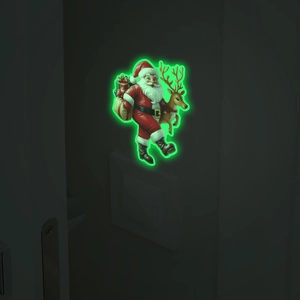 Glow-in-the-dark Christmas switch sticker with Santa and reindeer on wall in the dark