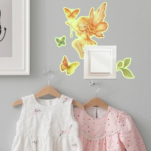 Luminous wall stickers featuring a fairy and butterflies around a light switch