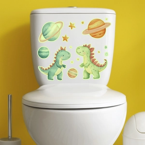 Detail of glow in the dark cartoon dinosaur and space planet stickers on toilet tank