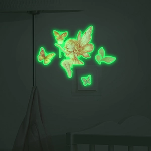 Luminous wall sticker showing a fairy and butterflies glowing in green at night