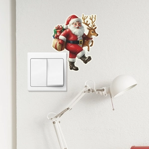 Luminous Santa Claus and reindeer wall sticker applied above a light switch in a home