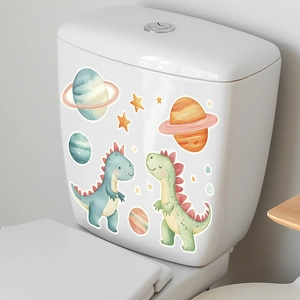 Close-up of watercolor cartoon dinosaur and planet luminous stickers on a white toilet tank
