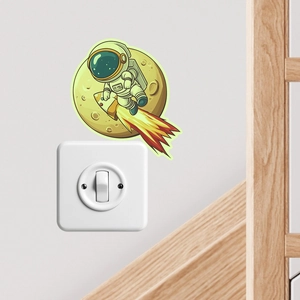 Detail of glow-in-the-dark astronaut and rocket sticker for wall switch decoration