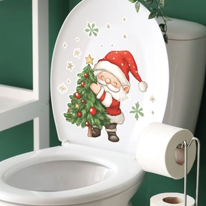 Détail de l'autocollant Père Noël et sapin de Noël posé sur un abattant de WC