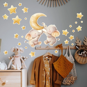 Detail showing cartoon elephant and moon wall stickers set in a cozy nursery room decor