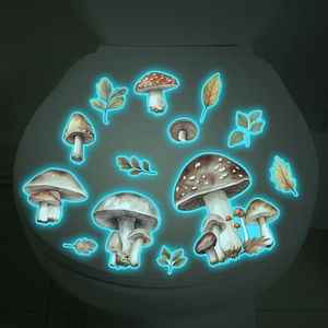 Luminous mushroom and autumn leaf decals showing blue glow effect on a bathroom toilet lid