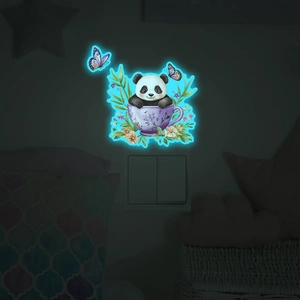 Luminous wall sticker with cartoon panda in flower tea cup glowing blue in dark room
