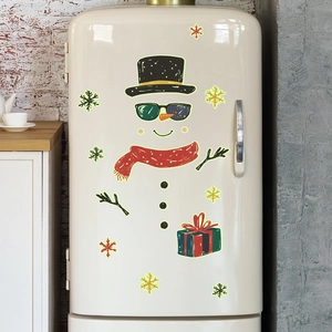 Luminous Christmas snowman fridge stickers with sunglasses and snowflakes on a beige surface