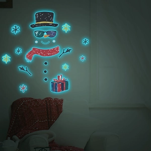 Luminous Christmas wall sticker showing glowing blue snowman and snowflakes in the dark