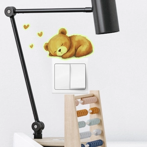 Glow-in-the-dark sleeping bear switch sticker for home decoration in cozy bedroom setting