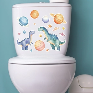 Close-up of watercolor dinosaur and planet stickers on white ceramic bathroom toilet tank
