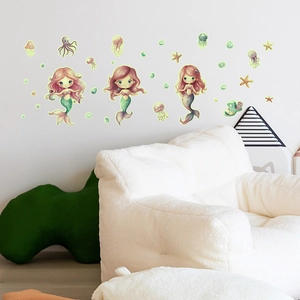 Luminous cartoon mermaid wall stickers with jellyfish and sea stars in a kids room