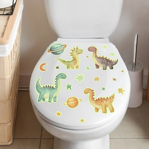 Detailed view of luminous cartoon dinosaur and moon stickers applied on a bathroom surface
