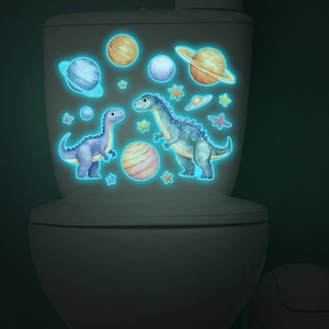 Glow-in-the-dark dinosaur and planet stickers glowing bright blue on a bathroom tank