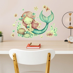Detail of colorful mermaid and shell wall decals in a cozy kids room decor setting