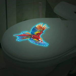 Luminous macaw parrot toilet lid sticker glowing with vibrant blue neon outlines at night