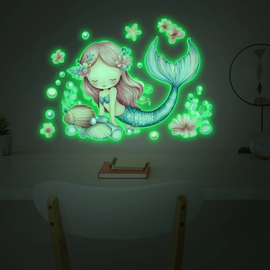 Luminous little mermaid and seashell wall stickers glowing in a dark bedroom setting