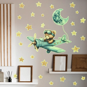 Glow-in-the-dark wall sticker featuring a bear pilot on a plane with stars and moon details