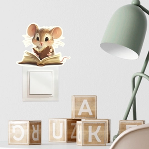 Macro detail of cartoon mouse reading a book glow sticker on a white light switch