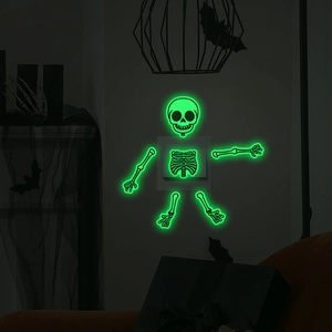 Luminous Halloween skeleton stickers showing glow in the dark effect around wall switch