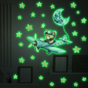 Luminous wall stickers showing a watercolor bear flying a plane with stars and moon