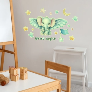 Detailed close-up of luminous flying elephant and stars wall stickers in a cozy nursery
