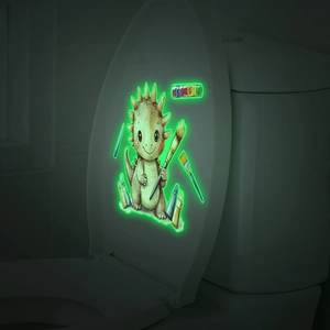 Sticker dinosaure tricolore phosphorescent sur couvercle de toilette blanc dans le noir