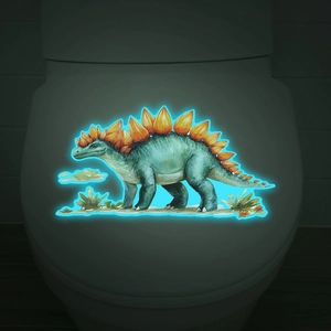 Luminous stegosaurus dinosaur wall sticker glowing in dark on a white toilet lid