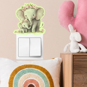 Luminous elephant wall sticker applied above light switch in cozy nursery room decor