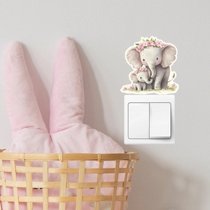 Luminous elephant wall sticker detail on a light switch in a cozy nursery room setting